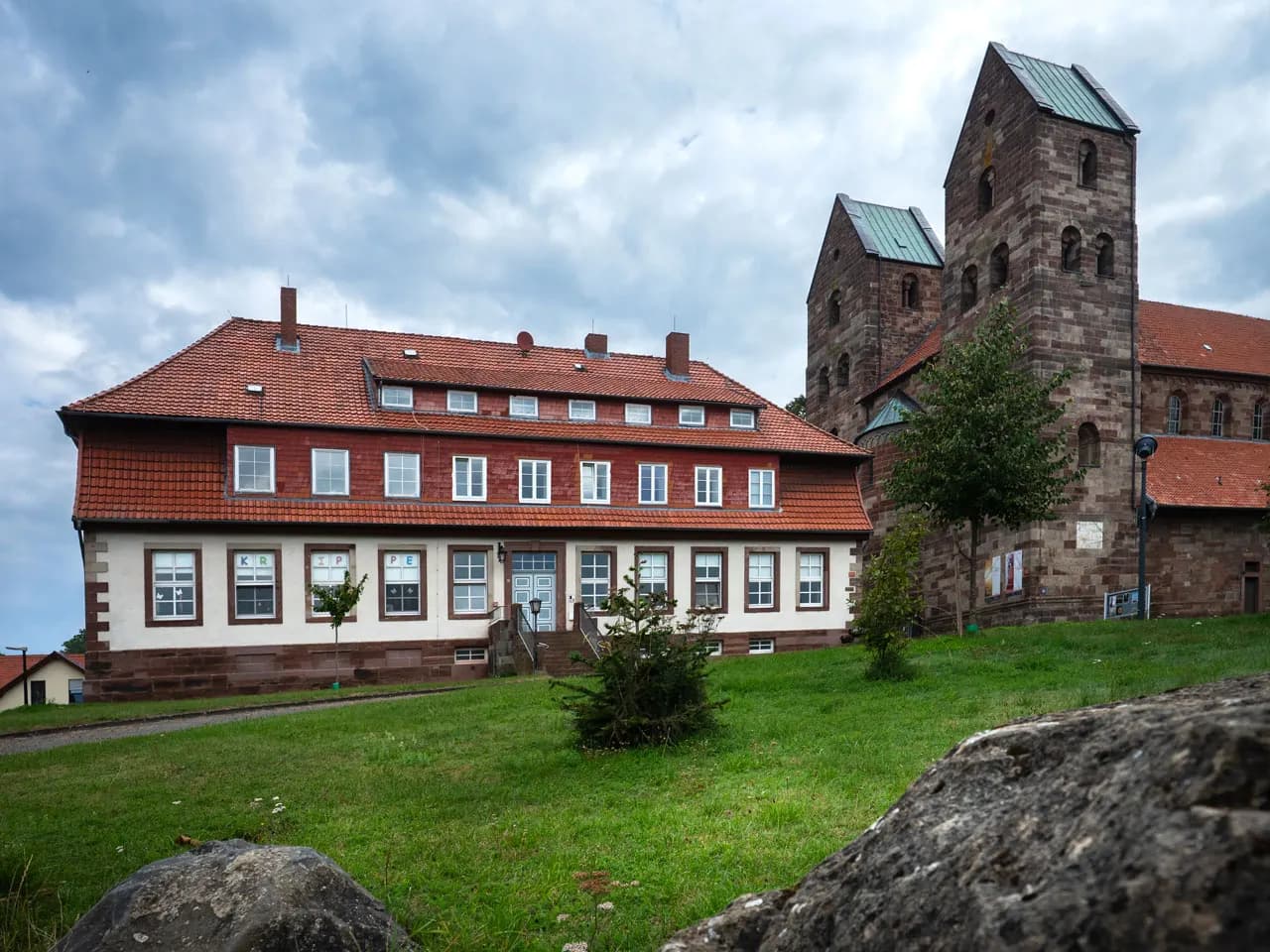 Heritage school building with timber windows next to a church