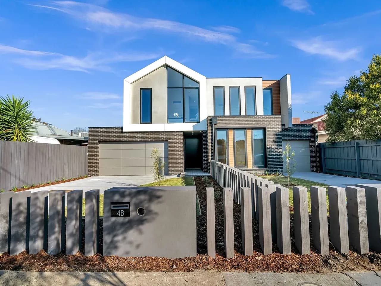 Modern house with timber windows and a slatted fence