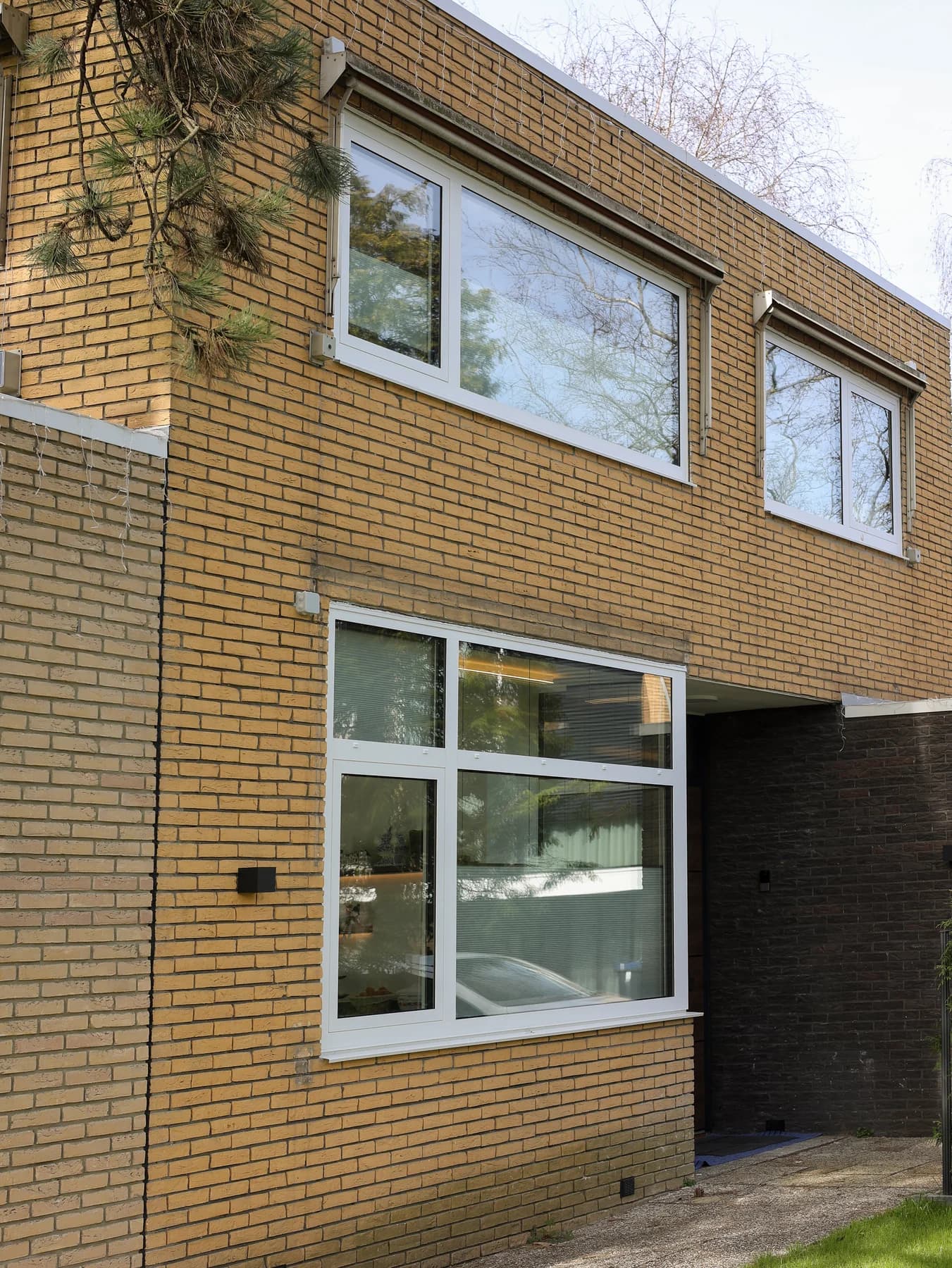 Brick front facade with light window frames