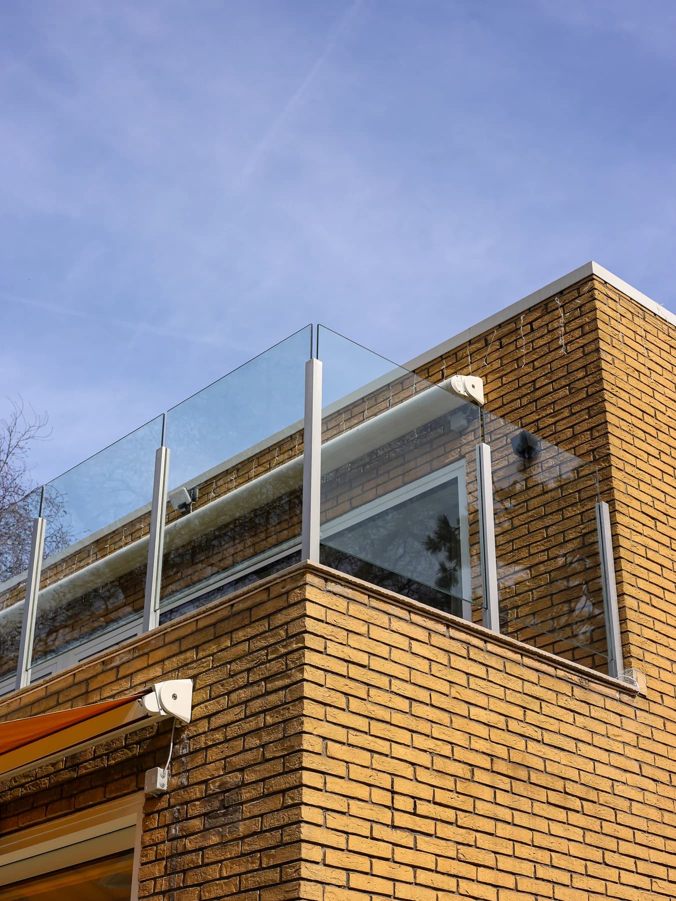 Wide upper-floor windows in the brick home