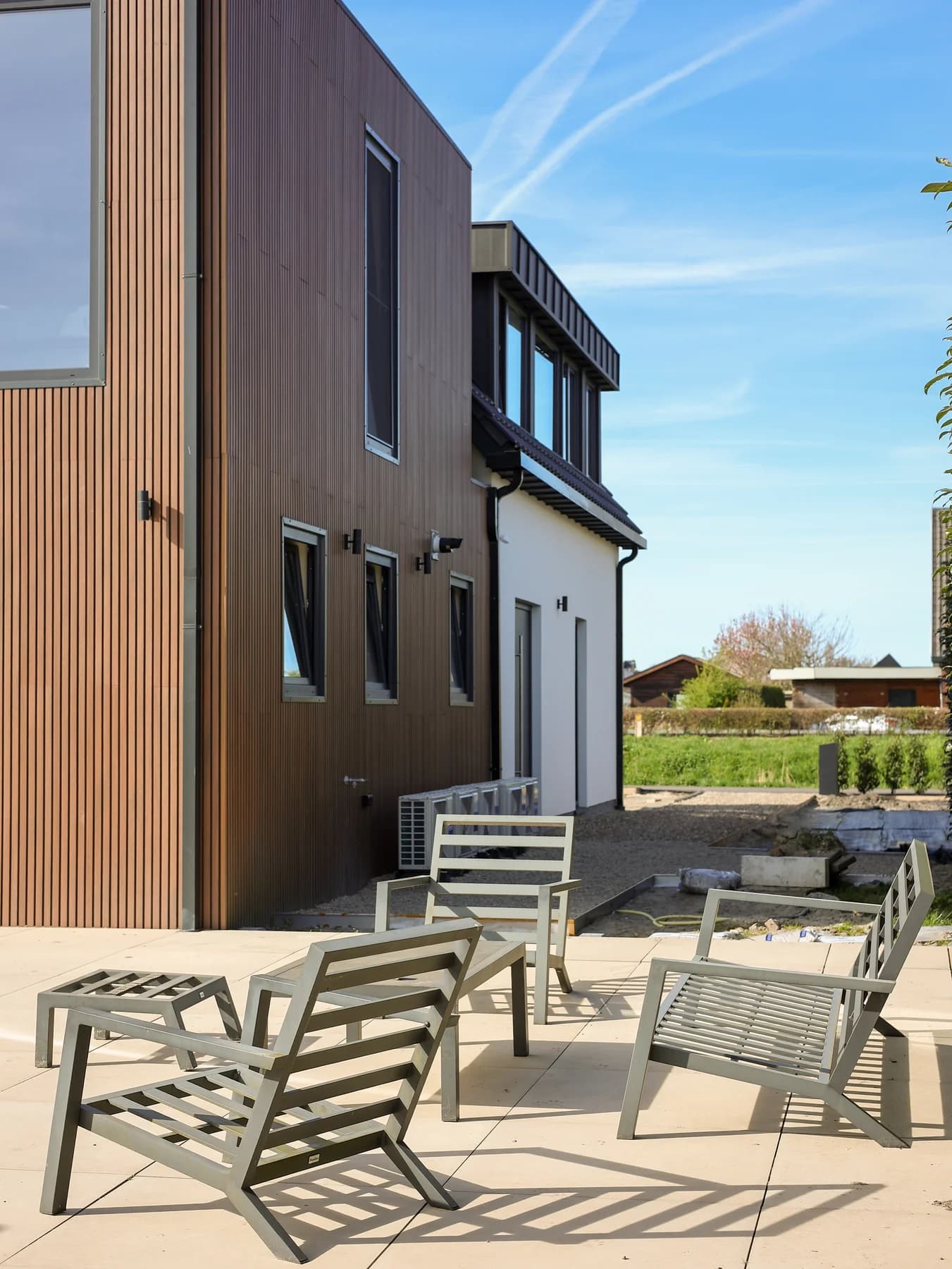 Timber home with a terrace and dark window frames