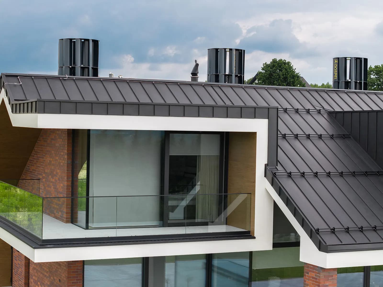 Modern house with a dark roof and large aluminium windows
