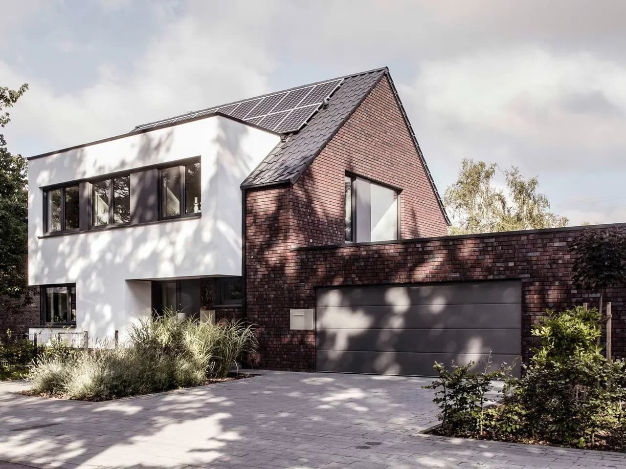 Modern house with white render, brick and wide windows